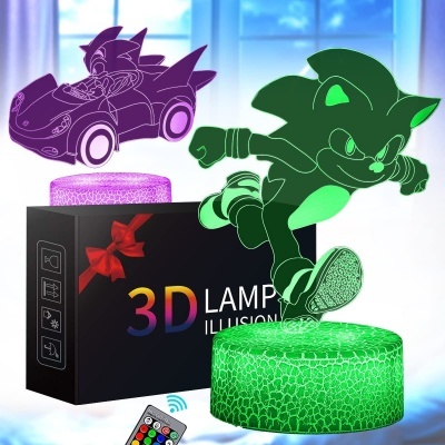 Lâmpada 3D com personagem animado, base verde e roxa, embalagem preta e telecomando.