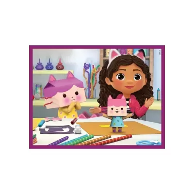 Menina animada com faixa de orelhas de gato e figura de papel de gato numa mesa com materiais de artesanato.