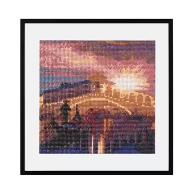 Quadro bordado de ponte iluminada ao pôr do sol em moldura preta