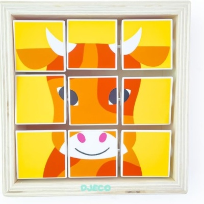 Quebra-cabeça de madeira com imagem de vaca em cores amarelo, laranja, branco e rosa