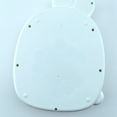 Figura branca oval com orelhas redondas e parafusos visíveis