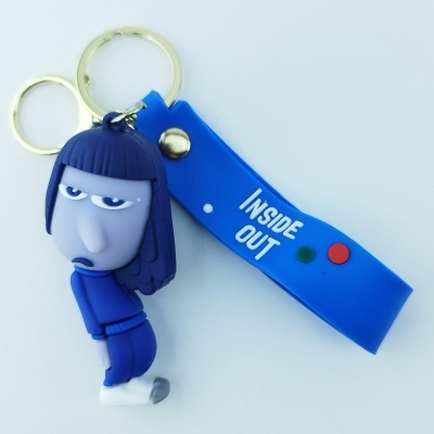 Porta-chaves com personagem de borracha azul e roxa e fita azul com texto 'INSIDE OUT'