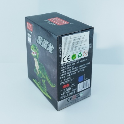 Embalagem preta com imagem de dinossauro verde em blocos de construção e texto em chinês