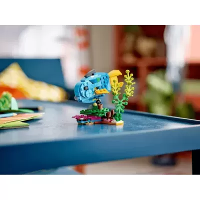 Modelo de peixe construído com blocos tipo LEGO sobre mesa azul