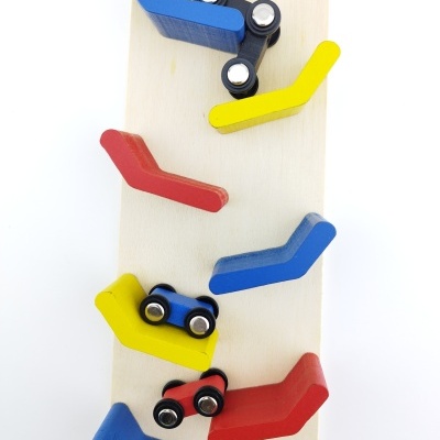 Brinquedo Montessori de madeira com estruturas angulares coloridas e carrinhos pequenos