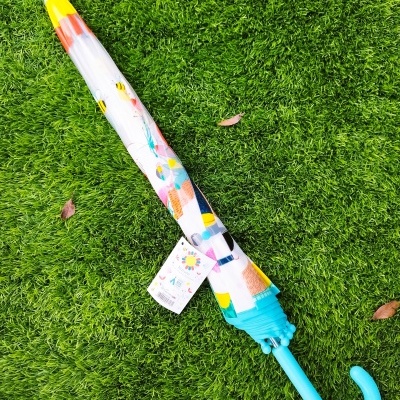 Guarda-chuva fechado colorido sobre relva artificial verde