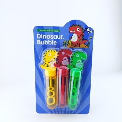 Três frascos de bolhas com tampas de dinossauro colorido em embalagem azul