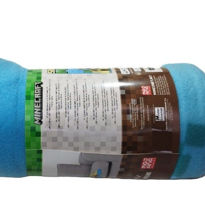 Manta de microfibra azul e castanha com embalagem do Minecraft