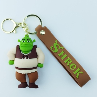 Porta-chaves com figura de borracha do personagem Shrek e tira castanha com texto 'SHREK'