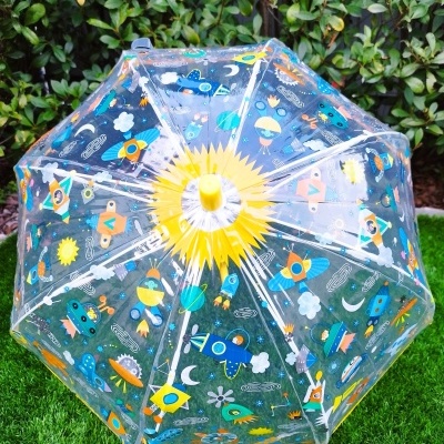 Guarda-chuva transparente decorado com naves espaciais e elementos espaciais coloridos.