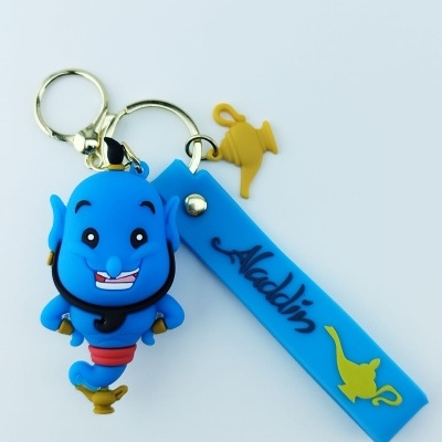 Porta-chaves azul com figura do génio do Aladdin, etiqueta azul e pendente em forma de lâmpada dourada