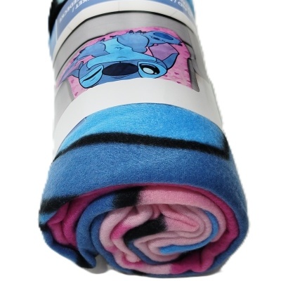 Manta dobrada de polar azul, rosa e preta com personagem Stitch na etiqueta