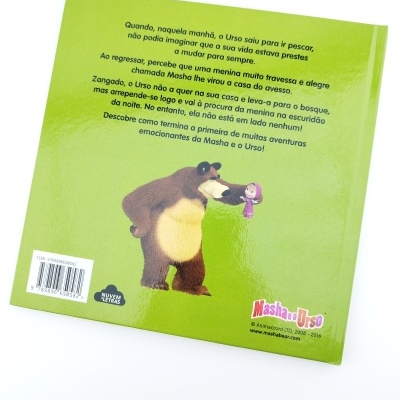 Capa traseira de livro infantil verde com ilustração de urso e menina, texto em português, logos e código de barras.