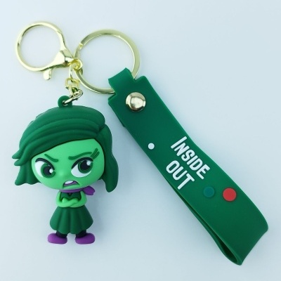 Porta-chaves verde com figura de personagem e pendente com texto INSIDE OUT