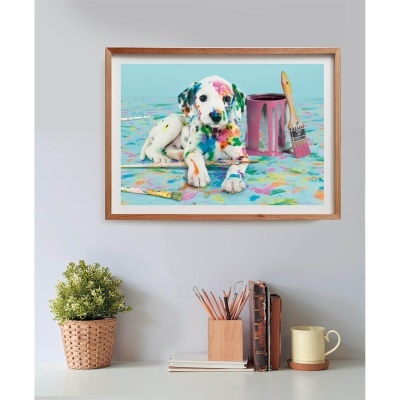 Quadro com imagem colorida de cachorro com tintas ao lado, em moldura de madeira