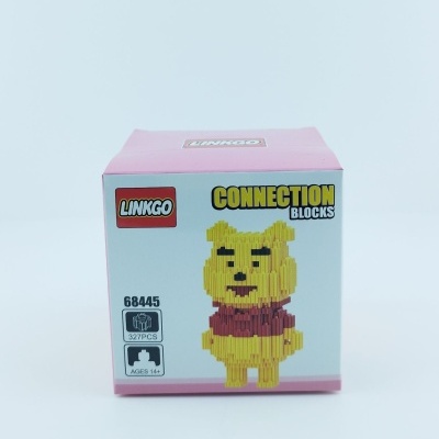Caixa rosa com blocos de construção LINKGO de um urso amarelo com camisa vermelha.