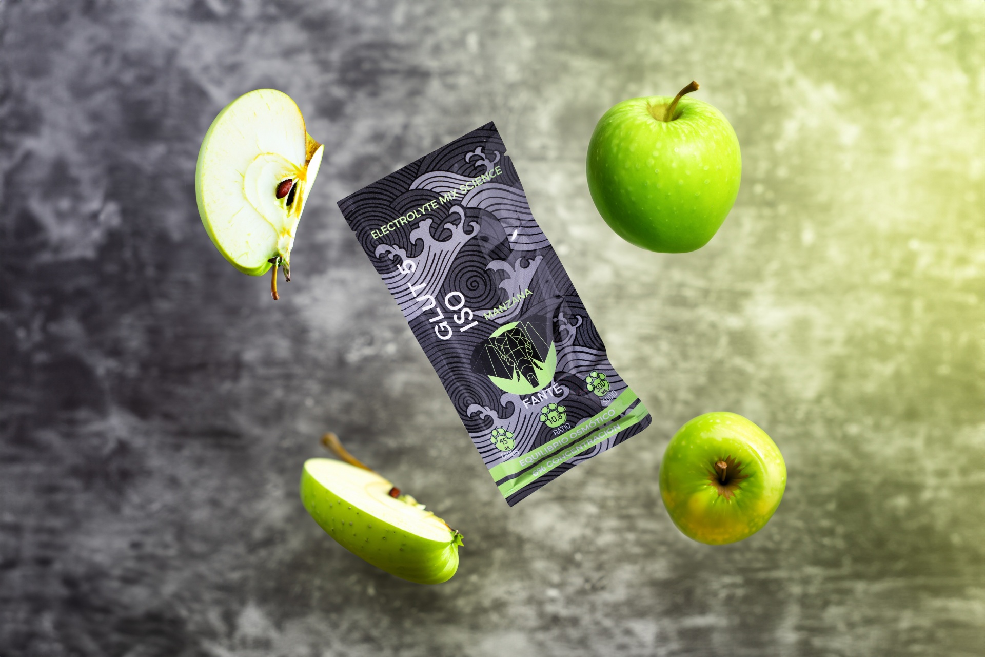 FANTÉ ISO DRINK MONODOSE Pacote preto com design gráfico GLUCO 90 rodeado por maçãs verdes num fundo cinzento.