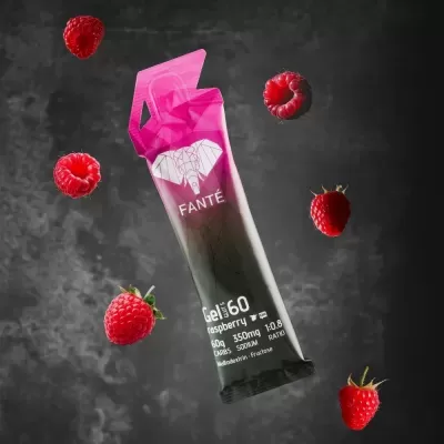 Pacote de gel energético FANTÉ com design preto e rosa, com elefante branco e texto sobre gel de framboesa, rodeado por framboesas.