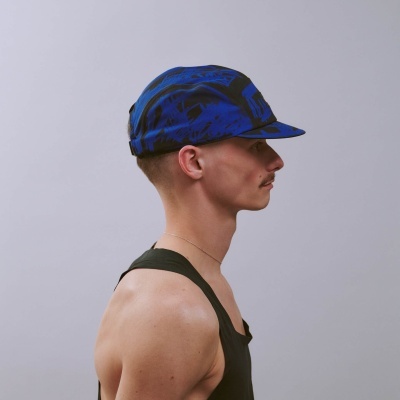 Boné azul e preto com padrão abstrato numa cabeça de perfil