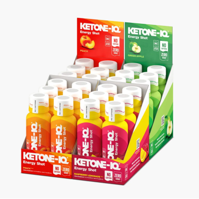 Caixa com frascos coloridos de KETONE-IQ Energy Shot, sabores pêssego, limonada de framboesa e maçã verde, embalagens coloridas com tampa branca.