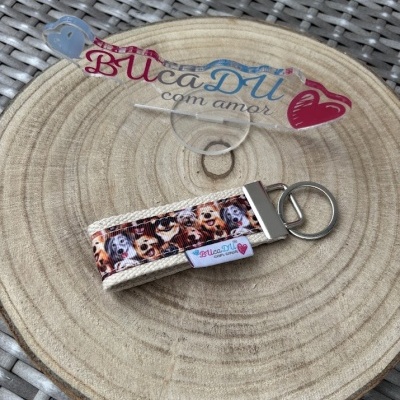 Chaveiro estampado com cães sobre superfície de madeira redonda