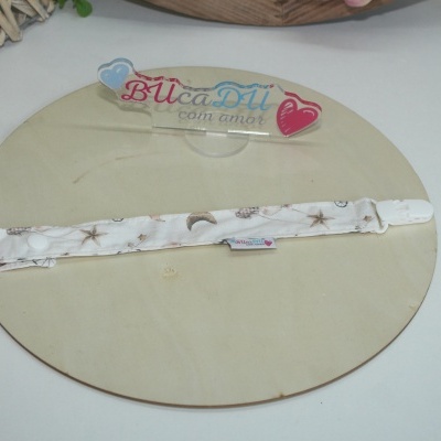 Tiralírios branco com padrão de estrelas e luas sobre base de madeira com placa acrílica