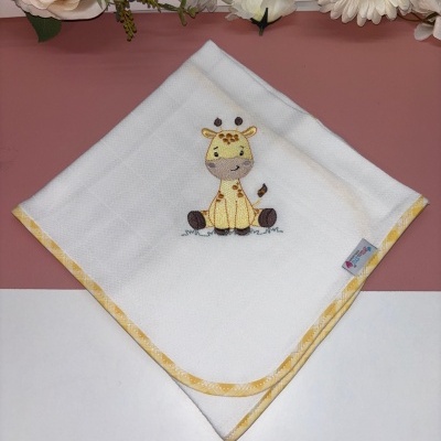 Fralda branca com bordos amarelos e bordado de girafa