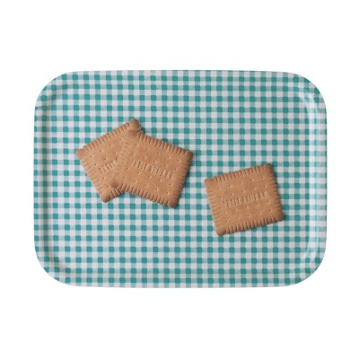 Biscoitos retangulares cor de caramelo num tabuleiro com padrão verde e branco