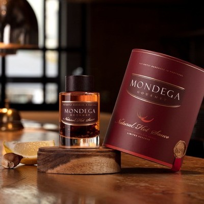 Frasco de whiskey e embalagem vermelha sobre mesa de madeira
