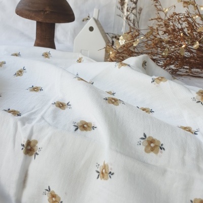 tecido branco com flores amarelas, cogumelo de madeira, casinha branca e ramos secos decorativos