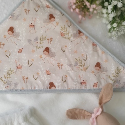 Toalha de banho de bebé com padrão de fadas e coelhos, e brinquedo de coelho macio.