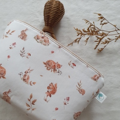 Necessaire branca com padrão de animais marrons e fecho