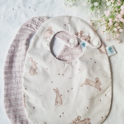 Conjunto de dois babetes de bebé com padrão de coelhos e riscas rosa