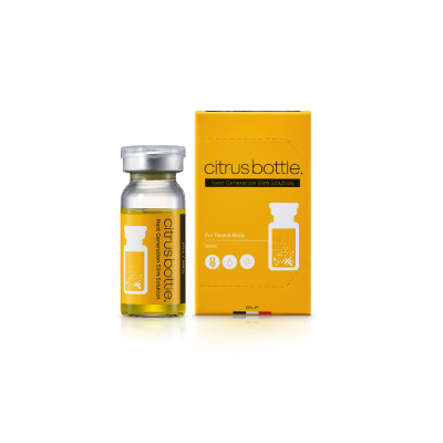 frasco de vidro com líquido amarelo e caixa amarela com texto citrus bottle