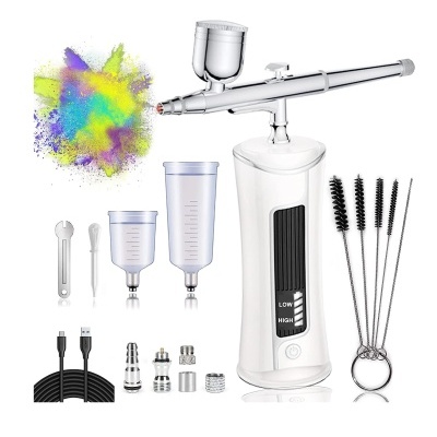 Conjunto de aerógrafo elétrico branco com acessórios e explosão de cor colorida