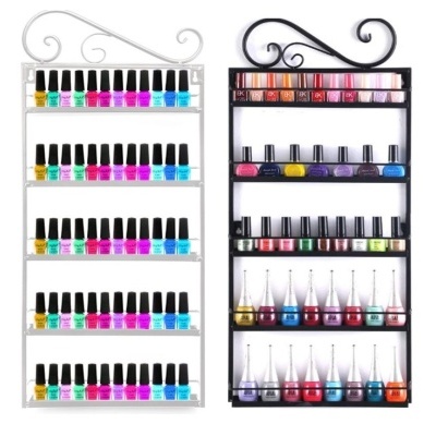 Organizadores de parede com várias garrafas de verniz de unhas coloridos em prateleiras horizontais.