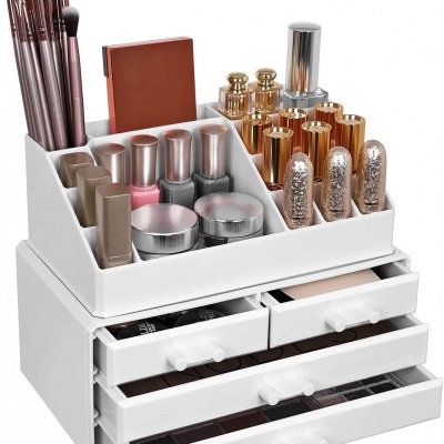 Organizador branco para maquilhagem com pincéis, vernizes, batons e gavetas com paletas de sombras.