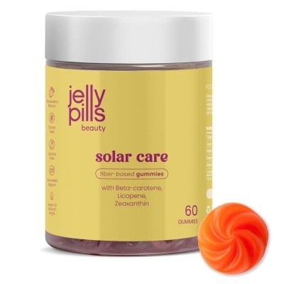 Frasco de gomas Jelly Pills Solar Care amarelo com tampa branca e goma laranja ao lado