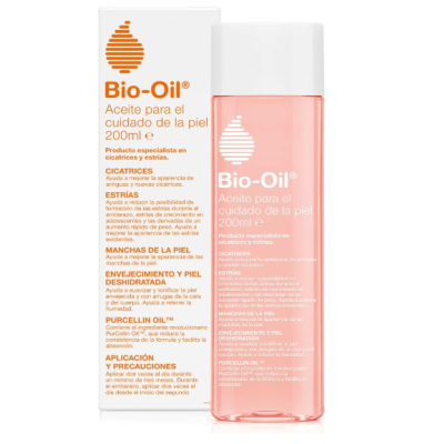Frasco rosado de Bio-Oil com tampa branca e caixa branca com texto em castelhano