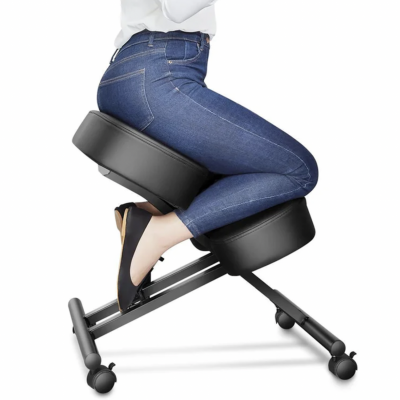 Cadeira ergonómica acolchoada preta com base metálica e rodas, com pessoa sentada de jeans e sapatos pretos.