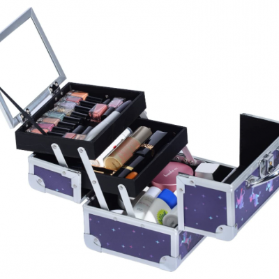 Estojo de maquilhagem lilás estrelado em metal com várias gavetas abertas e maquilhagem diversa no interior.