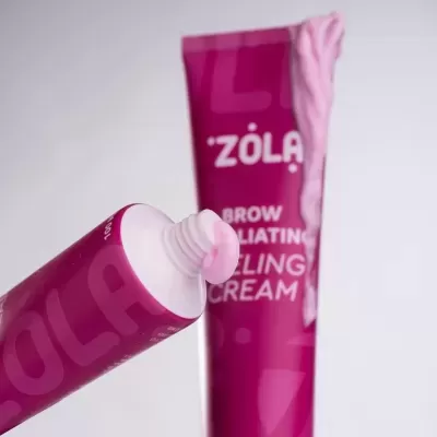 Tubo rosa escuro de creme esfoliante para sobrancelhas com creme rosa claro