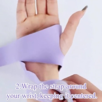 Aplicação de faixa de suporte roxa no pulso com instruções em texto.