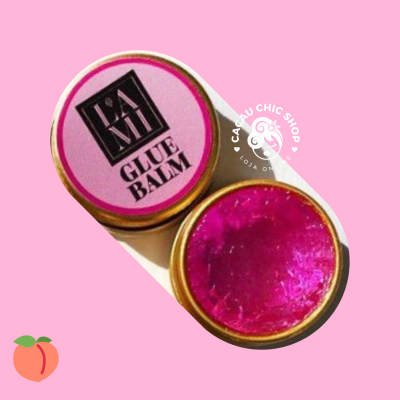 Pote dourado com tampa rosa e rótulo GLUE BALM com conteúdo rosa brilhante