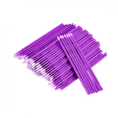 Cotonetes com haste roxa e pontas brancas sobre fundo branco