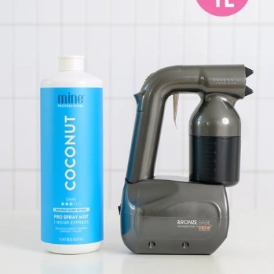 Frasco de óleo de coco azul e branco ao lado de pistola de bronzeamento cinza