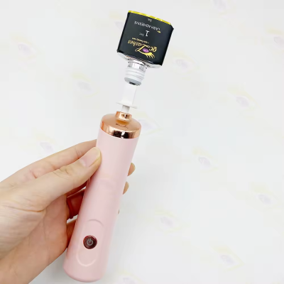 Dispositivo elétrico rosa com tubo de cola preta para pestanas