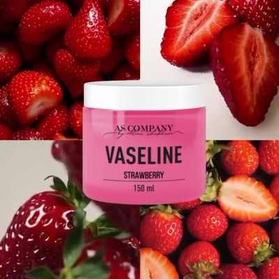 Frasco rosa de Vaseline Morango e morangos frescos ao redor