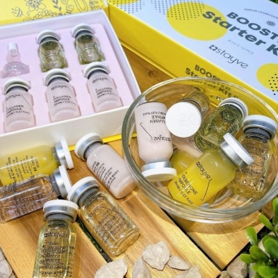 Kit BOOST Starter Kit Stayve com ampolas de vidro coloridas numa caixa amarela e branca e tigela de vidro