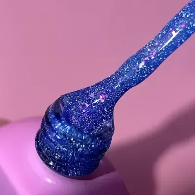 Pincel com verniz azul glitter em frasco rosa